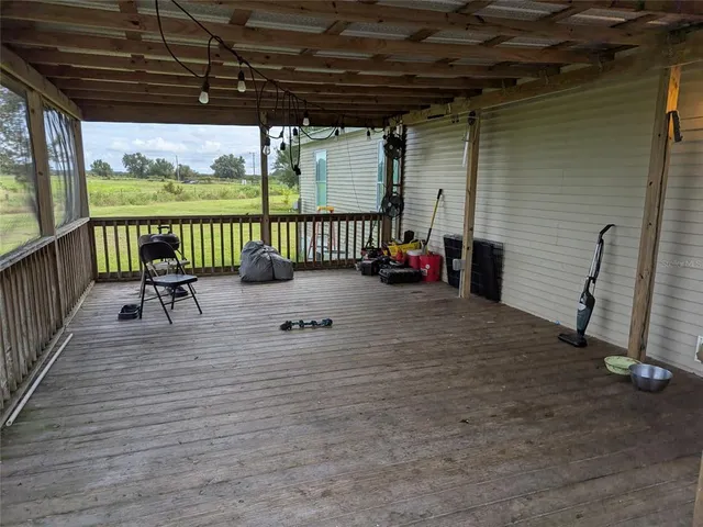 a view of a porch with furniture and garden