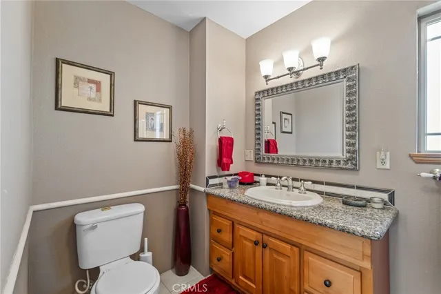 a bed sitting in a bedroom next to a window with kitchen countertops and a dresser