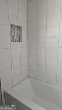 a bathroom with a toilet a sink and shower