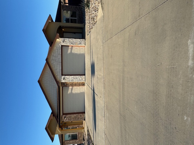 Single story duplex with driveway and an attached garage