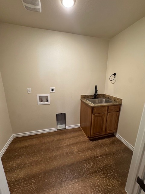 101 Calvin Smith Ln., Unit B Jarrell, TX 76537 - Photo 11 of 33 Laundry room featuring wood-style floors, hookup for a washing machine, cabinet space with sink, and electric dryer hookup!