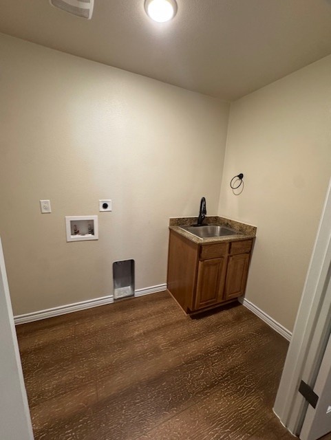 101 Calvin Smith Ln., Unit B Jarrell, TX 76537 - Photo 12 of 33 Spacious Laundry room with wood-like flooring, cabinet space with sink, hookup for a washing machine, and electric dryer hookup!