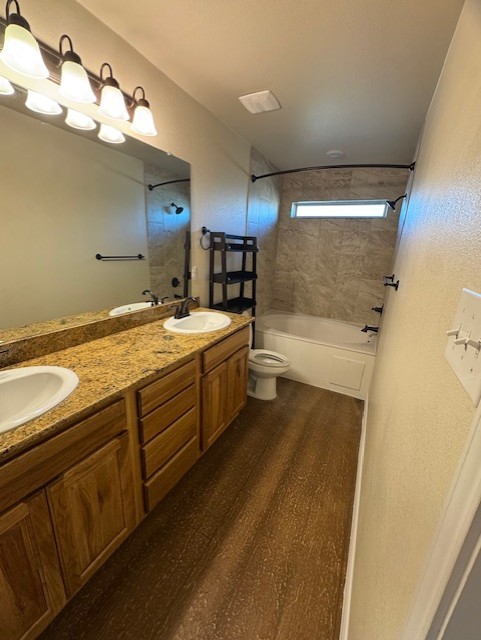 101 Calvin Smith Ln., Unit B Jarrell, TX 76537 - Photo 15 of 33 Bathroom with double vanity, wood-like flooring, and shower / bath combination