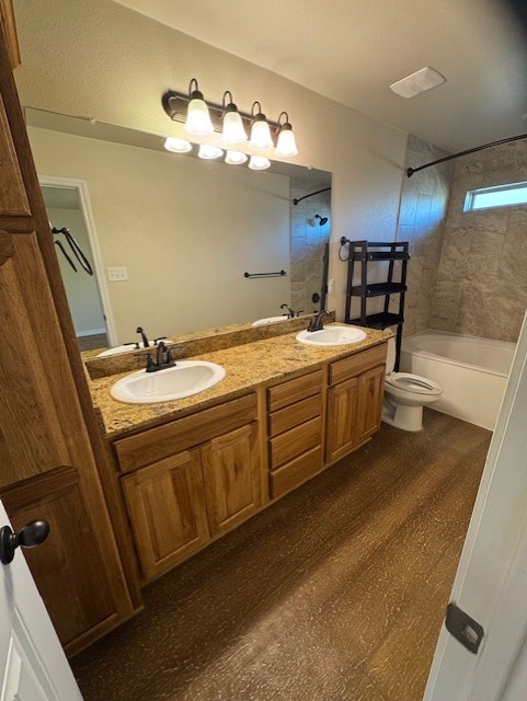 101 Calvin Smith Ln., Unit B Jarrell, TX 76537 - Photo 16 of 33 Primary Bathroom featuring double vanity, shower combination, and wood-like floors!