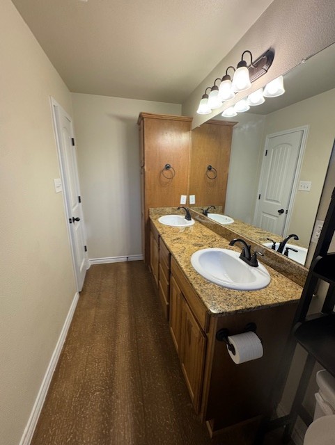 101 Calvin Smith Ln., Unit B Jarrell, TX 76537 - Photo 17 of 33 Primary Bathroom with double vanity and baseboards