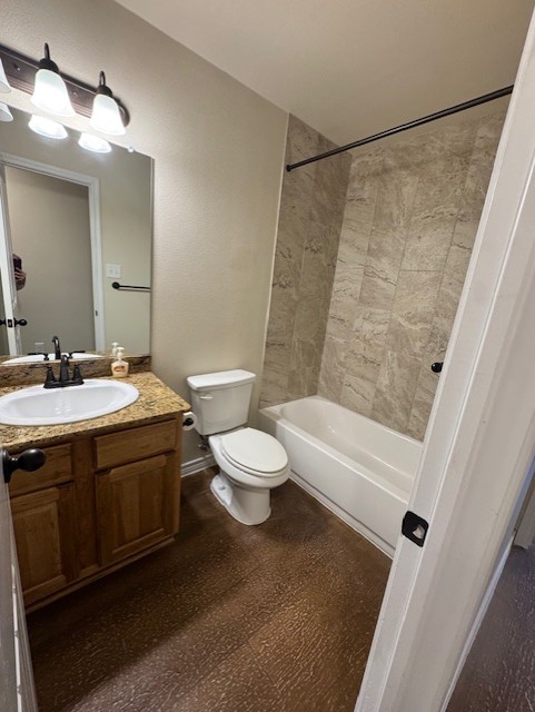 101 Calvin Smith Ln., Unit B Jarrell, TX 76537 - Photo 20 of 33 Bathroom featuring vanity, shower / bath combination, and dark wood-style flooring