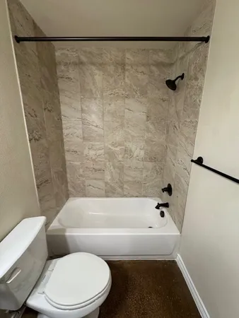 a bathroom with a bathtub and a toilet