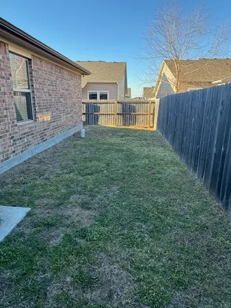 a view of backyard with seating area