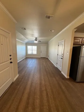 a view of wooden floor and windows in an empty room