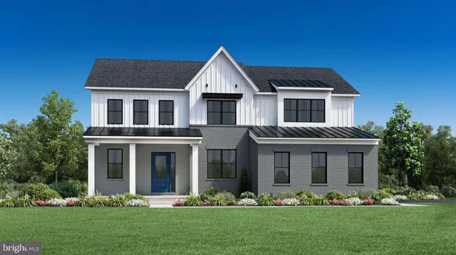 a front view of a house with a garden and plants