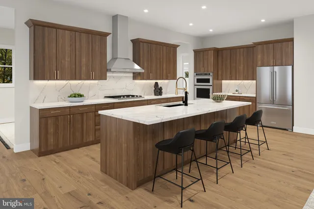 a kitchen with stainless steel appliances granite countertop a table chairs sink refrigerator and cabinets