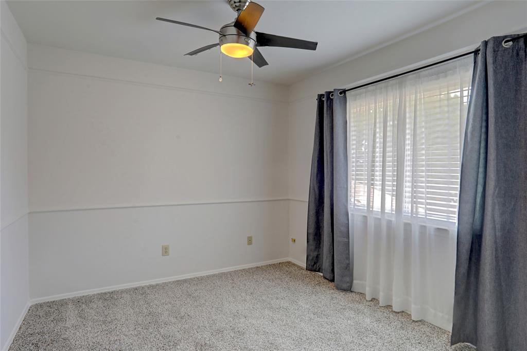 3411 Beech Street Rowlett, TX 75089 - Photo 21 of 32 an empty room with a window and a ceiling fan