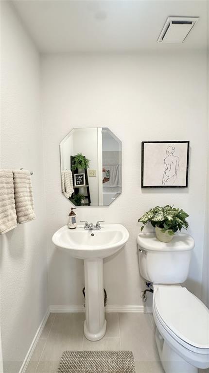 3411 Beech Street Rowlett, TX 75089 - Photo 23 of 32 a bathroom with a toilet a sink and mirror