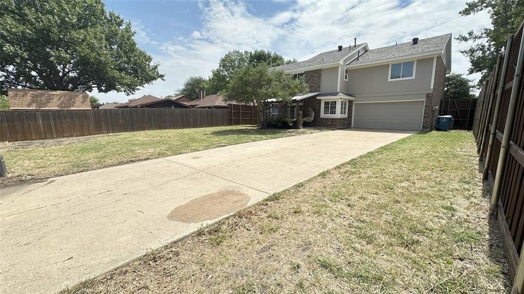 3411 Beech Street Rowlett, TX 75089 - Photo 31 of 32 a front view of a house with a yard and garage