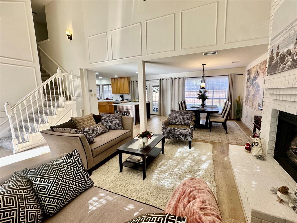 3411 Beech Street Rowlett, TX 75089 - Photo 5 of 32 a living room with furniture a fireplace and a flat screen tv