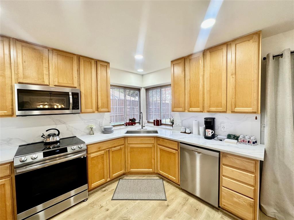 3411 Beech Street Rowlett, TX 75089 - Photo 8 of 32 a kitchen with a sink stove top oven and cabinets