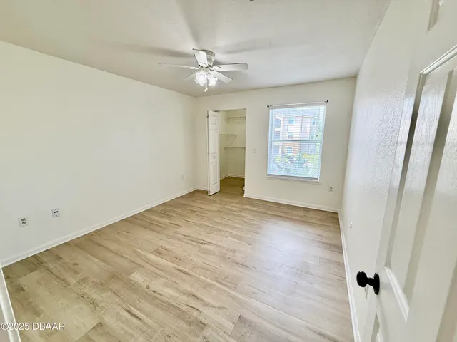 wooden floor in an empty room with a window