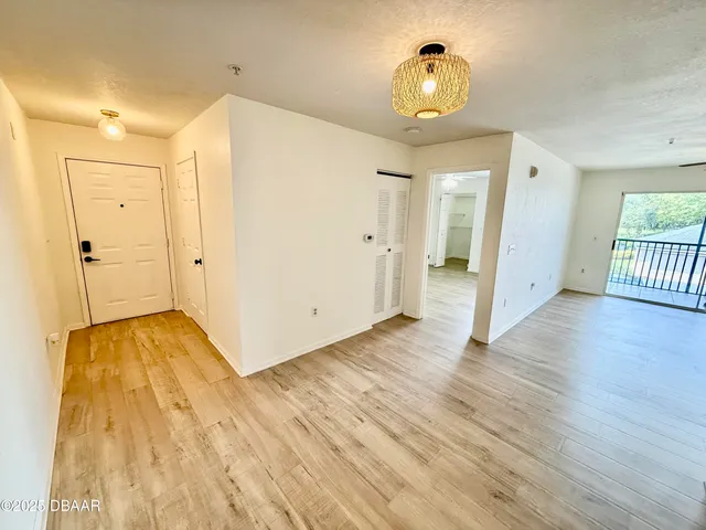 a view of a hallway with wooden floor
