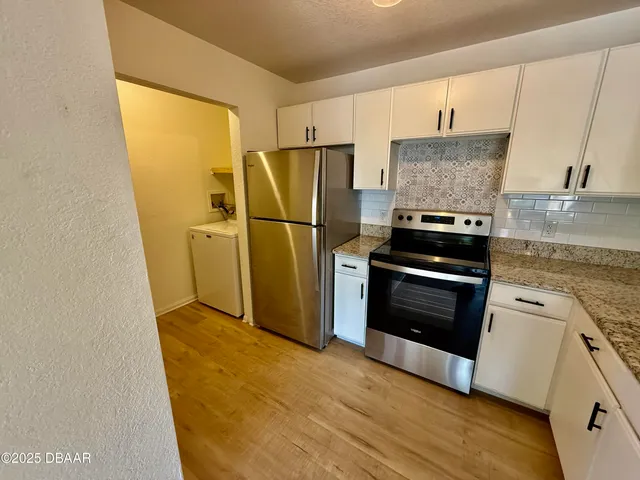 a kitchen with a refrigerator sink and stove