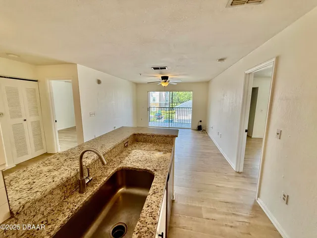 a view of a livingroom with wooden floor and entryway