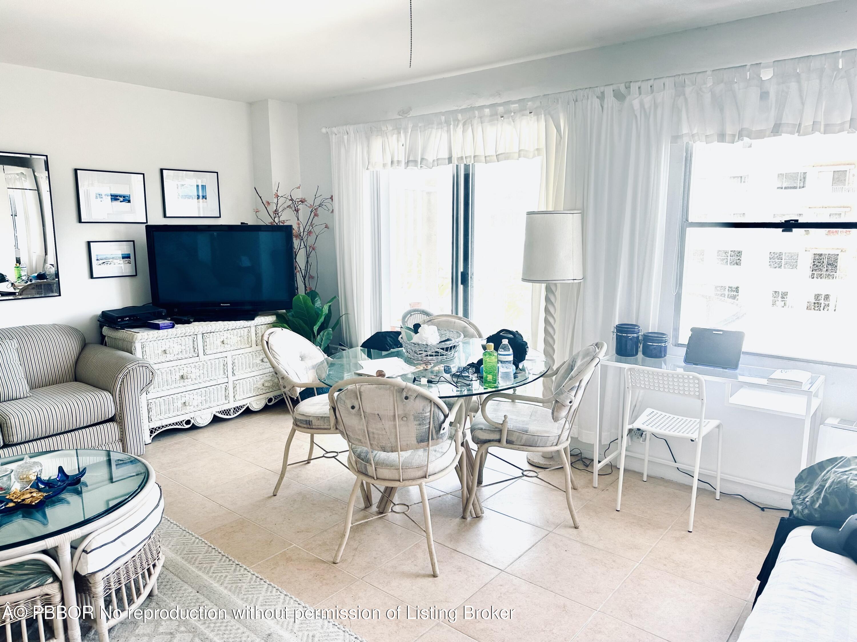 44 Cocoanut Row, Unit 509B Palm Beach, FL 33480 - Photo 2 of 7 a living room with furniture and a large window
