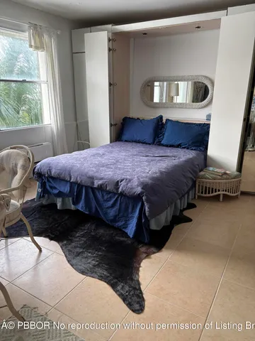 a bed sitting in a bedroom next to a window