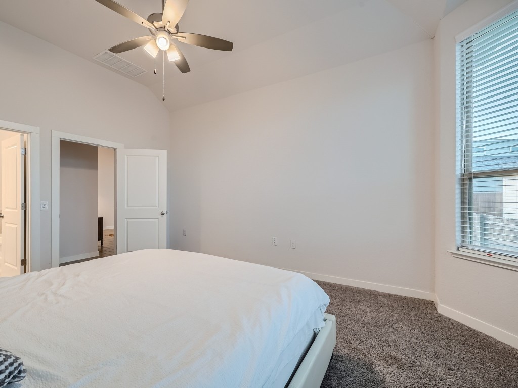 11400 American Mustang Loop Manor, TX 78653 - Photo 13 of 24 a bedroom with a large bed and a window