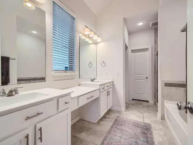 a spacious bathroom with a double vanity sink mirror double and bathtub