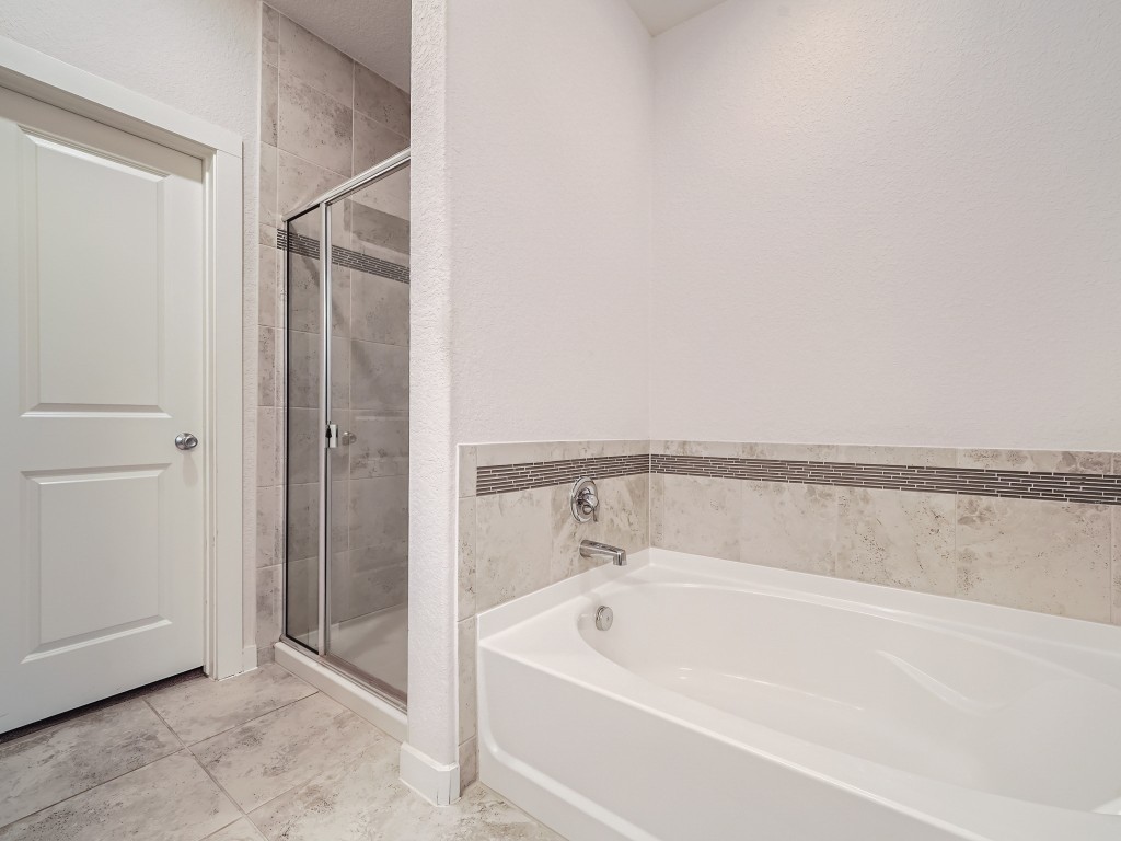 11400 American Mustang Loop Manor, TX 78653 - Photo 15 of 24 a bathroom with a bathtub
