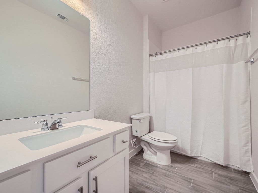 11400 American Mustang Loop Manor, TX 78653 - Photo 17 of 24 a bathroom with a sink toilet and a mirror