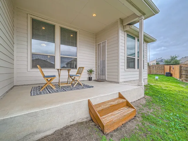 a view of a chair and table in patio of the house