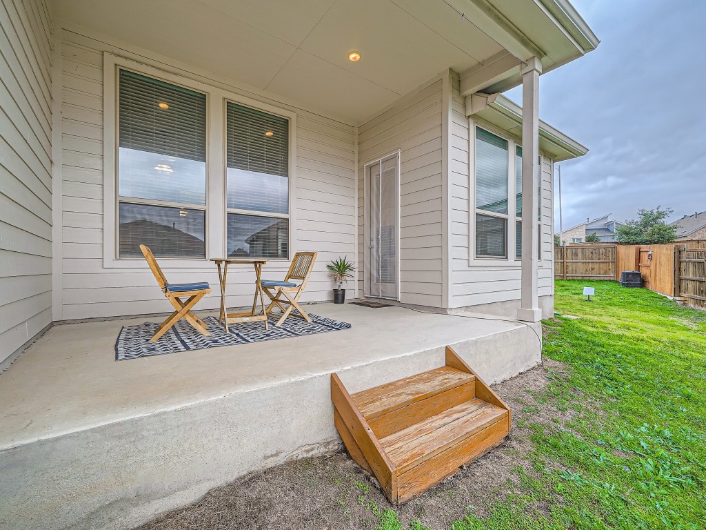 11400 American Mustang Loop Manor, TX 78653 - Photo 20 of 24 a view of a chair and table in patio of the house