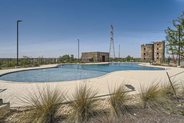 a view of a swimming pool with a yard