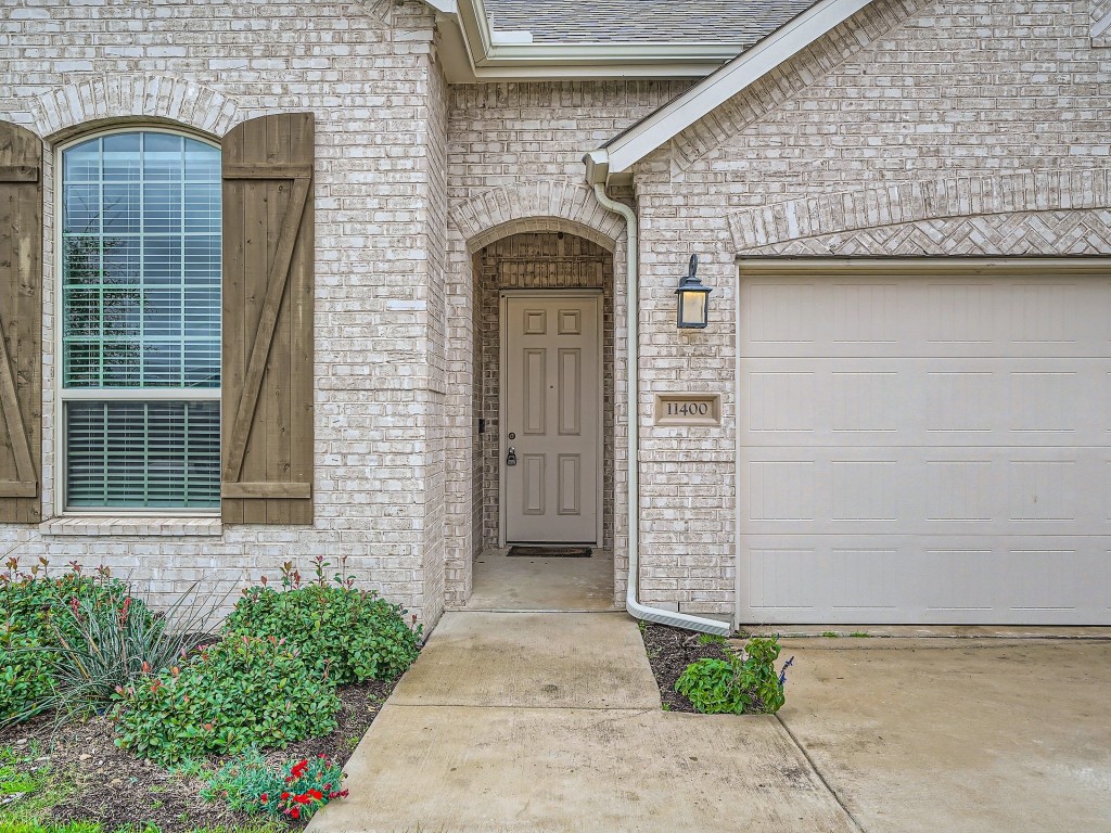 11400 American Mustang Loop Manor, TX 78653 - Photo 3 of 24 a front view of a house with garage
