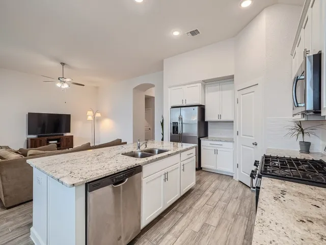a kitchen with a stove a sink and a refrigerator