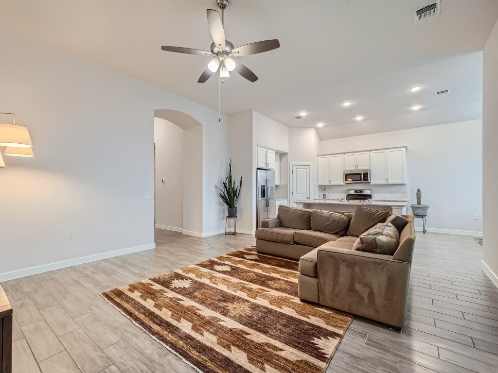 11400 American Mustang Loop Manor, TX 78653 - Photo 9 of 24 a living room with furniture and a chandelier