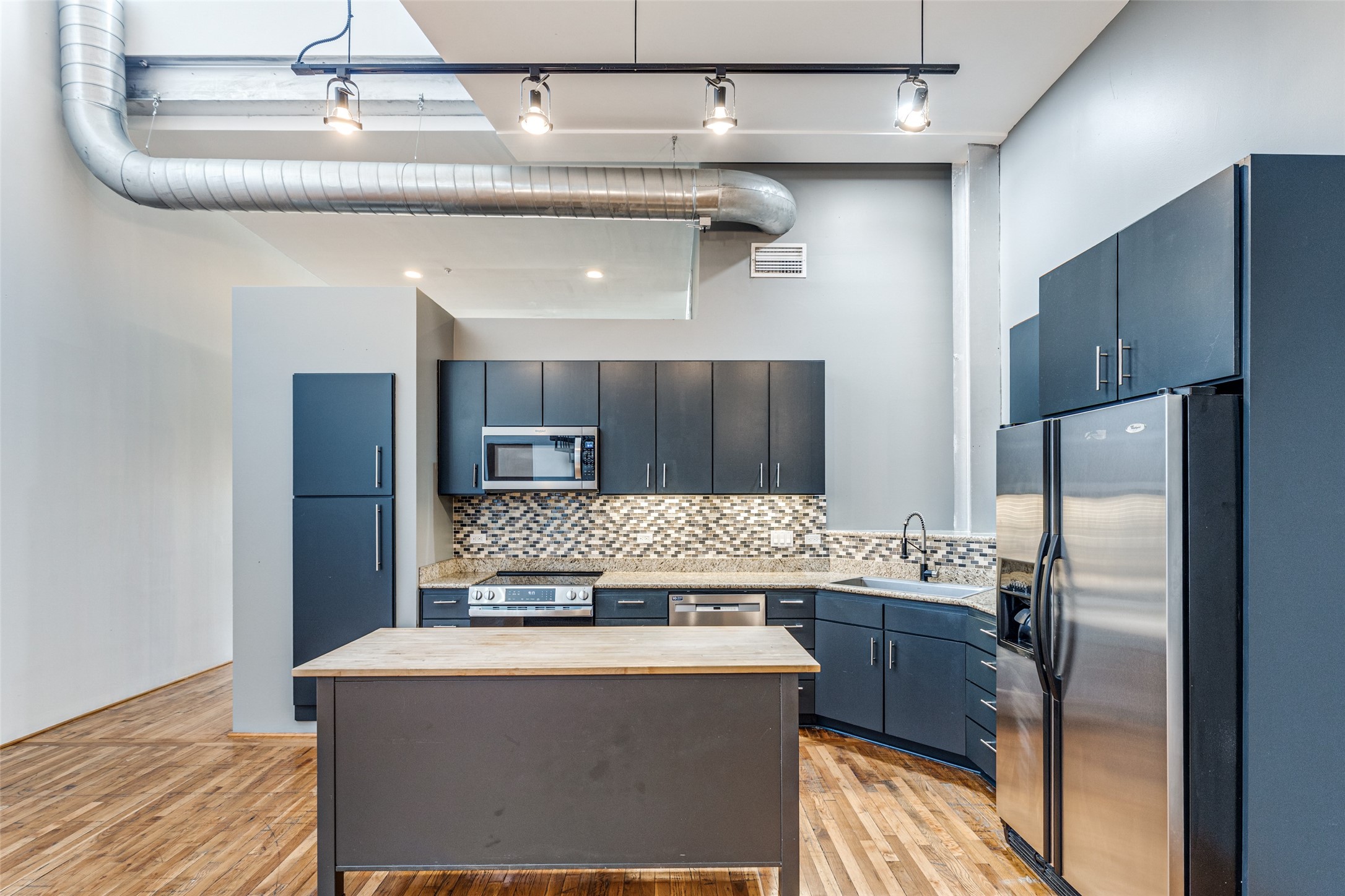 1312 Live Oak Street, Unit 223 Houston, TX 77003 - Photo 8 of 31 Kitchen island and workspace with open sightlines to the living area, ideal for entertaining.