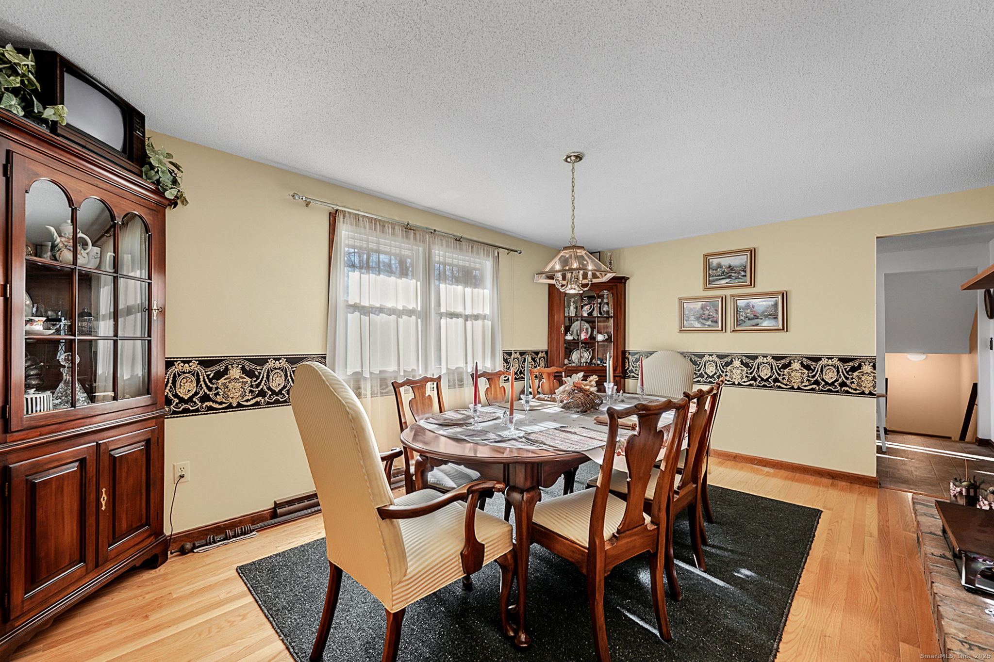52 Wood Creek Road Burlington, CT 06013 - Photo 11 of 40 a view of a dining room with furniture and wooden floor