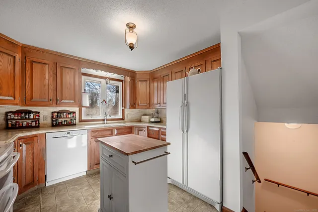 a kitchen with stainless steel appliances a refrigerator sink and cabinets