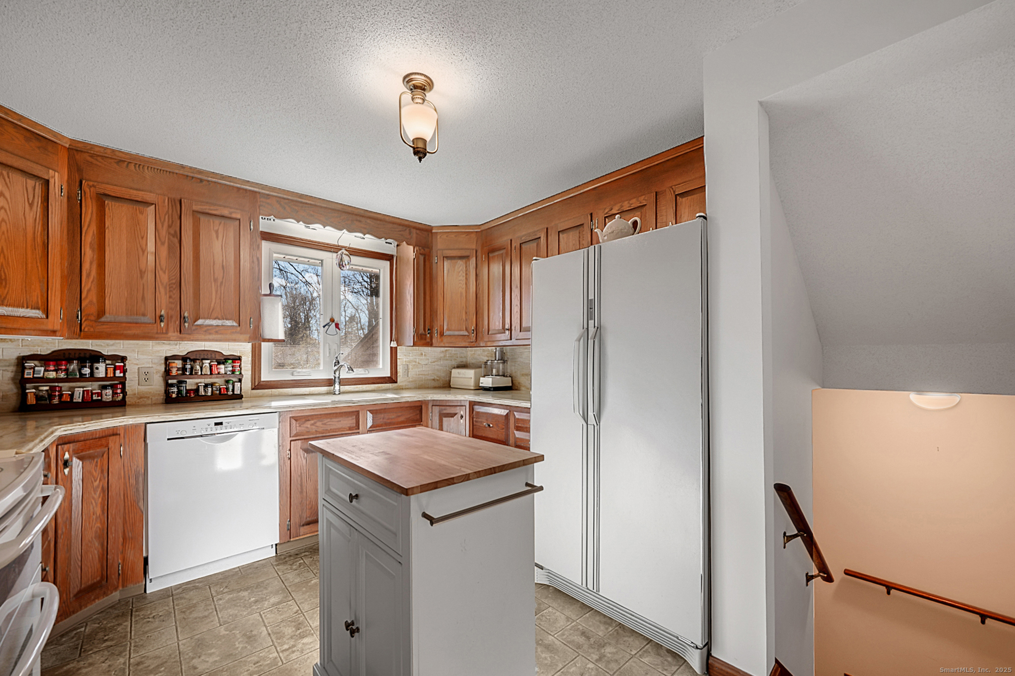 52 Wood Creek Road Burlington, CT 06013 - Photo 13 of 40 a kitchen with stainless steel appliances a refrigerator sink and cabinets