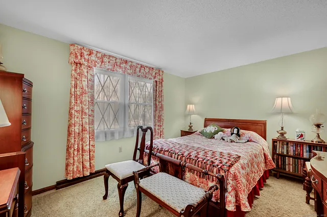 a bedroom with a bed and a large window