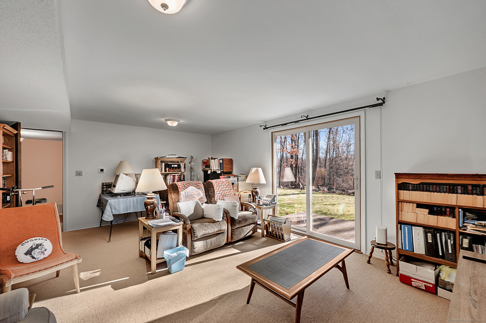 52 Wood Creek Road Burlington, CT 06013 - Photo 28 of 40 a living room with furniture a bookshelf and a window