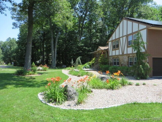 52 Wood Creek Road Burlington, CT 06013 - Photo 34 of 40 a front view of a house with garden
