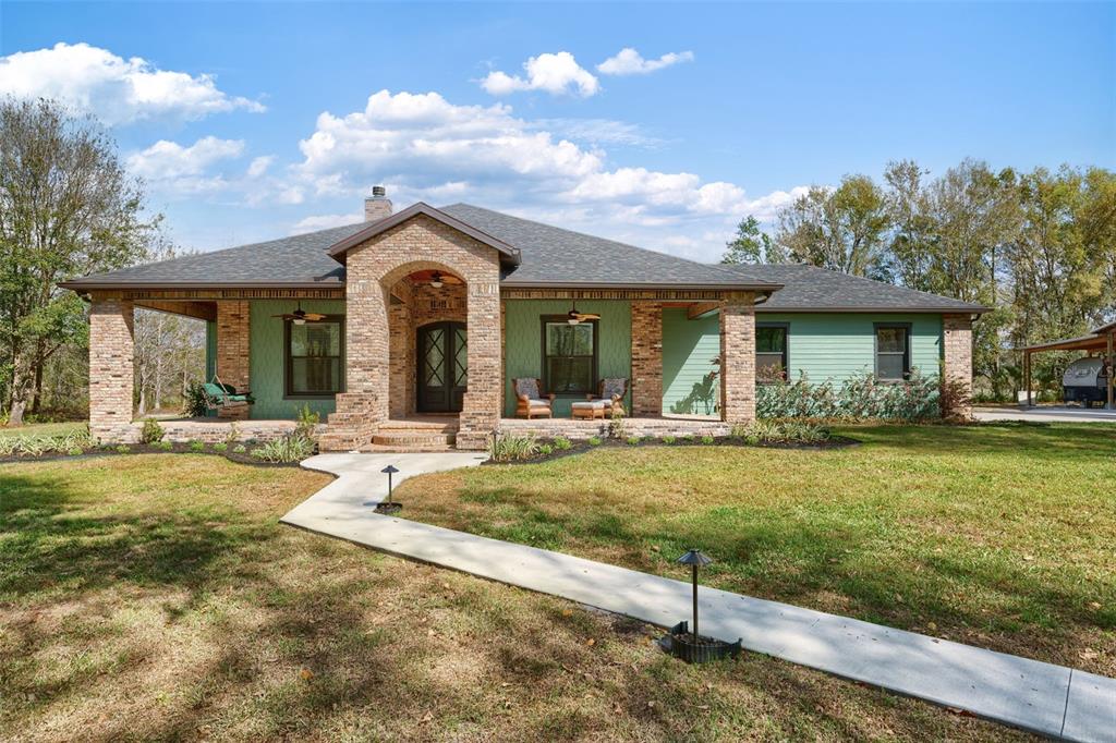 a view of a house with swimming pool and a yard
