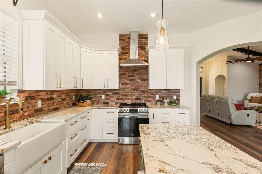 6206 Five Acre Road Plant City, FL 33565 - Photo 11 of 33 a kitchen with stainless steel appliances kitchen island granite countertop a sink and cabinets