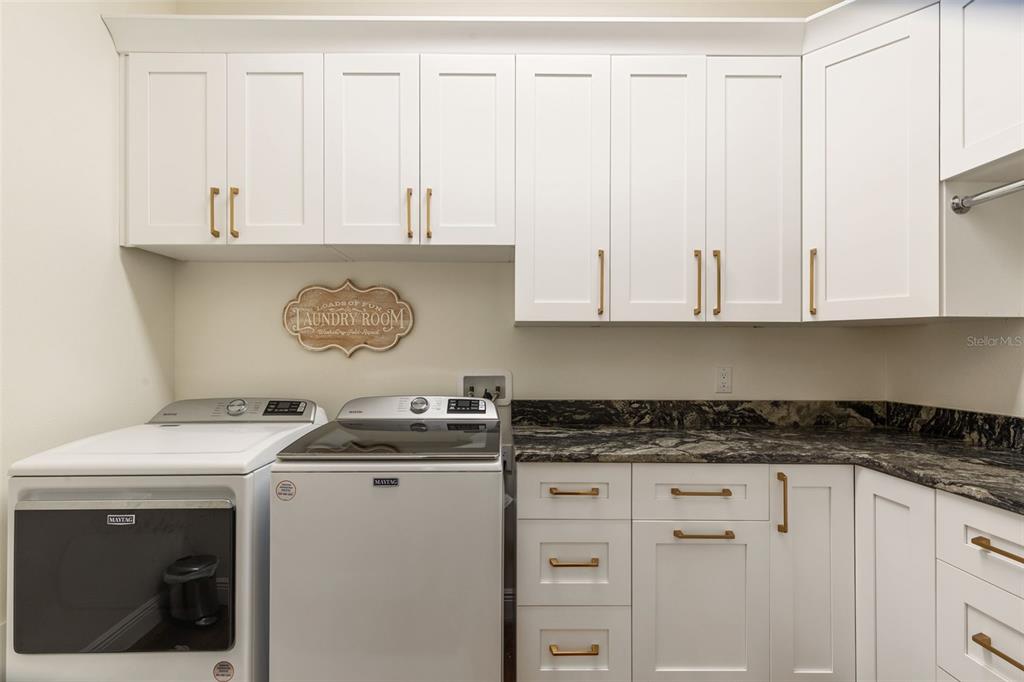 6206 Five Acre Road Plant City, FL 33565 - Photo 26 of 33 a kitchen with granite countertop white cabinets and white appliances
