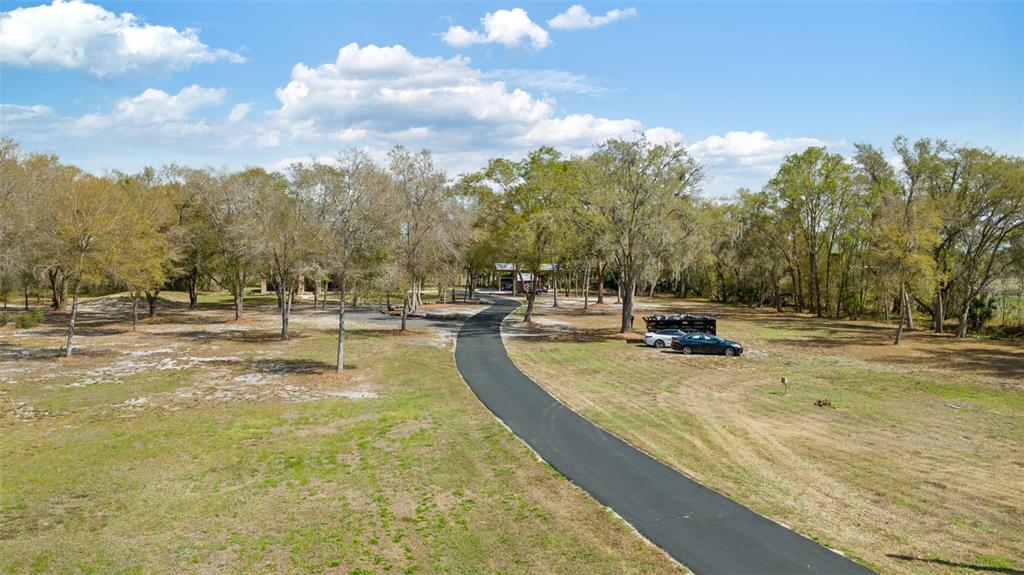 6206 Five Acre Road Plant City, FL 33565 - Photo 29 of 33 a view of a swimming pool with an outdoor space and seating area