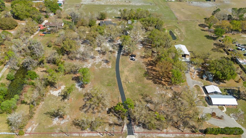 6206 Five Acre Road Plant City, FL 33565 - Photo 3 of 33 a aerial view of a residential houses with yard