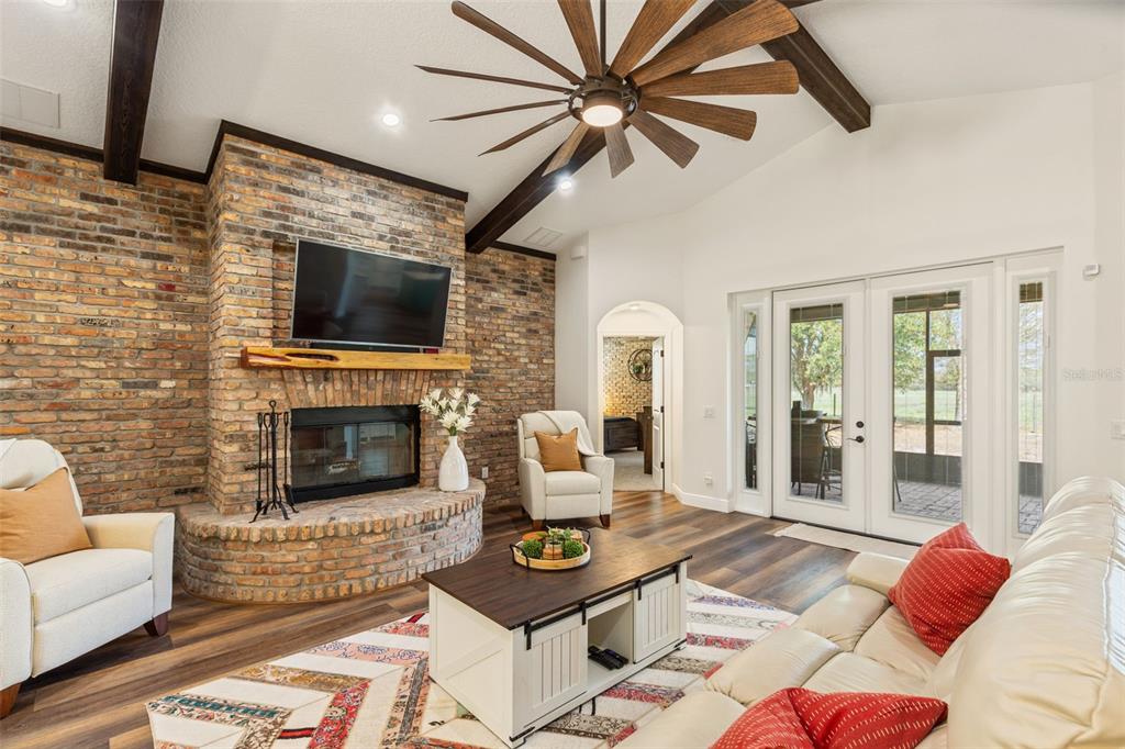 6206 Five Acre Road Plant City, FL 33565 - Photo 7 of 33 a living room with furniture a fireplace and a flat screen tv