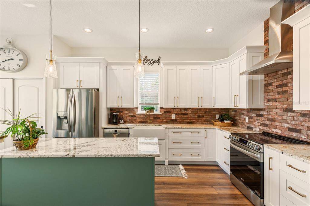 6206 Five Acre Road Plant City, FL 33565 - Photo 9 of 33 a kitchen with stainless steel appliances granite countertop a stove a sink and a refrigerator